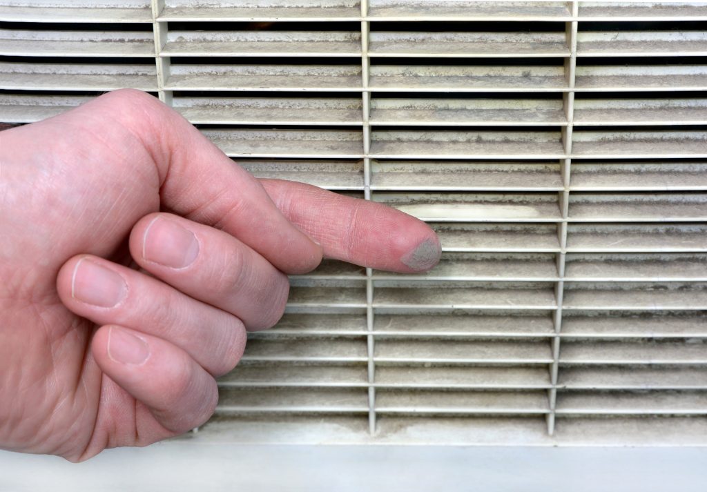 Person checks the contamination of the ventilation grille stock photo