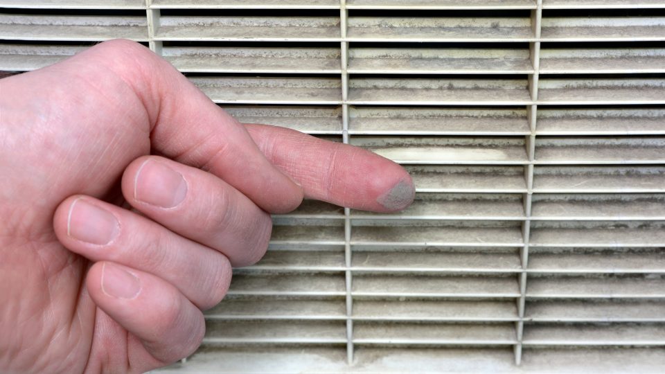 Person checks the contamination of the ventilation grille stock photo