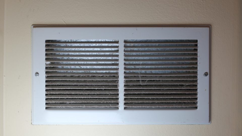 close-up of dusty air register ventilation system dirty needs cleaning abstract background